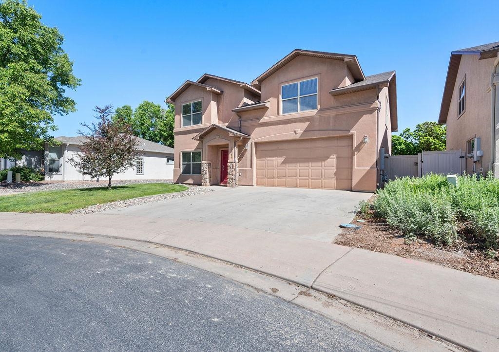 2436 1/2 Jack Creek Road Grand Junction, CO 81505 - Photo 2 of 36 a front view of a house with a yard and garage