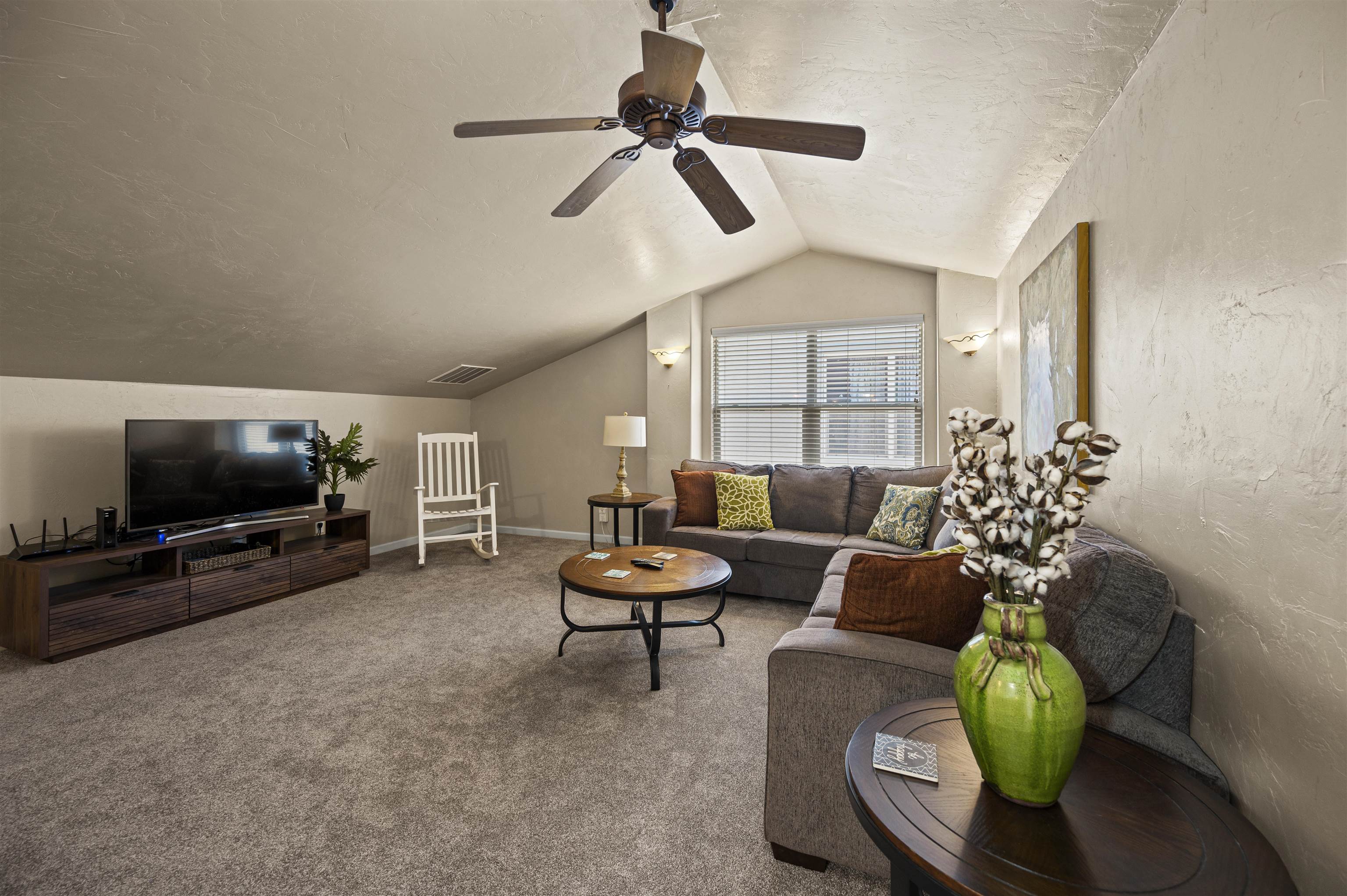 2436 1/2 Jack Creek Road Grand Junction, CO 81505 - Photo 23 of 36 a living room with furniture and a flat screen tv