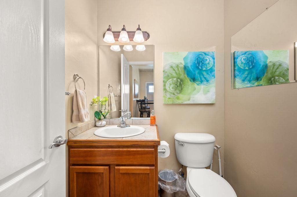 2436 1/2 Jack Creek Road Grand Junction, CO 81505 - Photo 24 of 36 a bathroom with a toilet a sink and a mirror