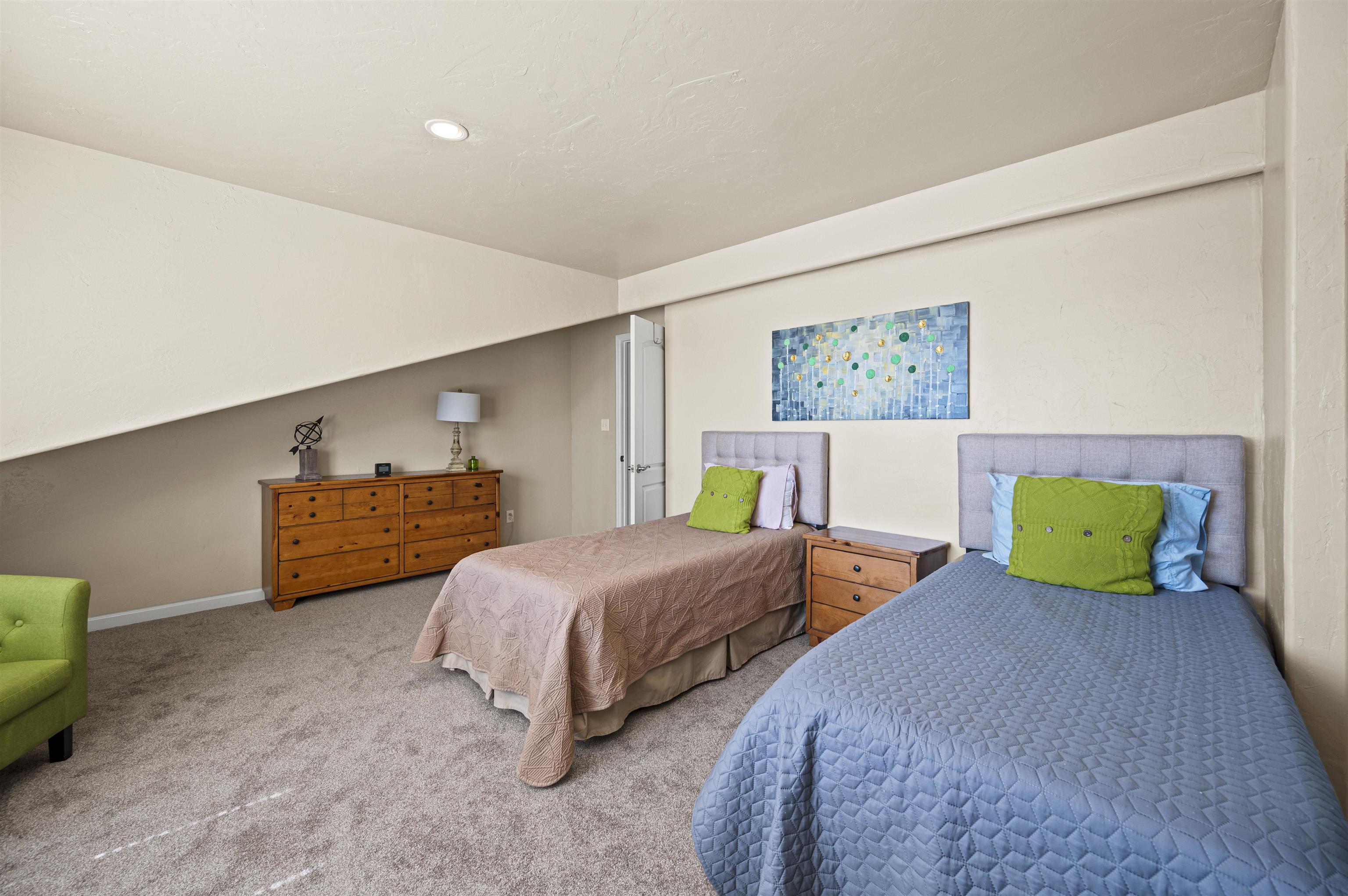 2436 1/2 Jack Creek Road Grand Junction, CO 81505 - Photo 29 of 36 a bedroom with two beds and painting on the wall