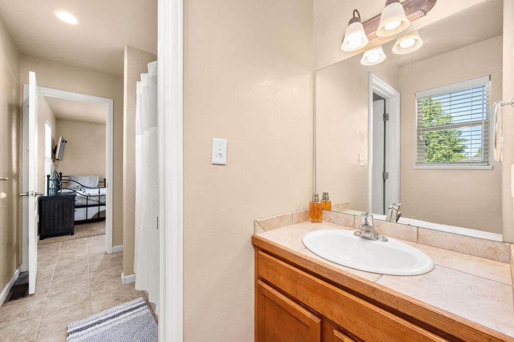 2436 1/2 Jack Creek Road Grand Junction, CO 81505 - Photo 30 of 36 a en suite bathroom with a sink a large mirror and a shower