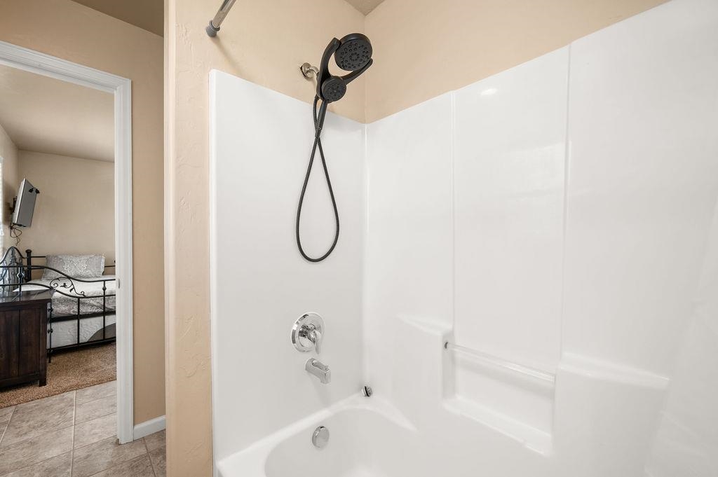 2436 1/2 Jack Creek Road Grand Junction, CO 81505 - Photo 31 of 36 a bathroom with a bath tub with a shower