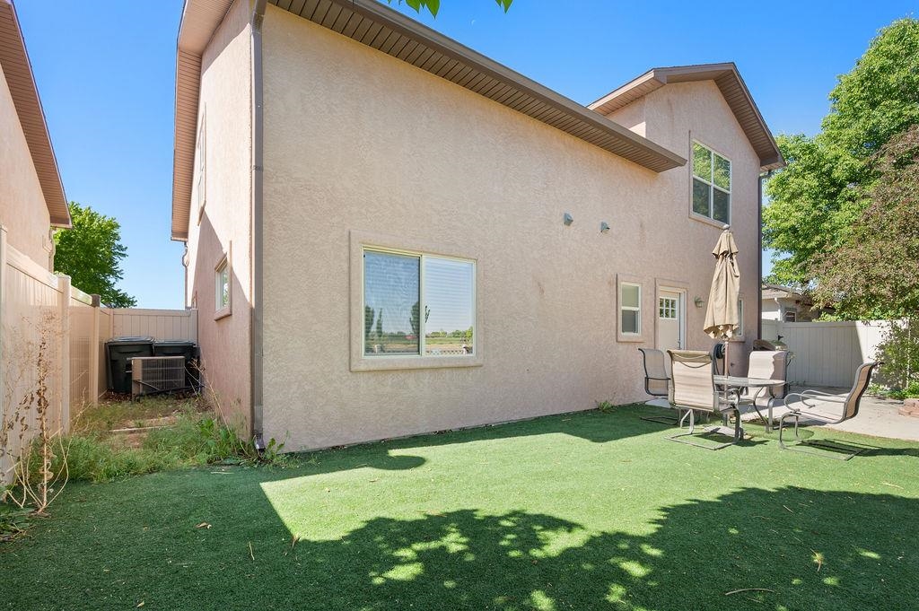 2436 1/2 Jack Creek Road Grand Junction, CO 81505 - Photo 33 of 36 a backyard of a house with table and chairs