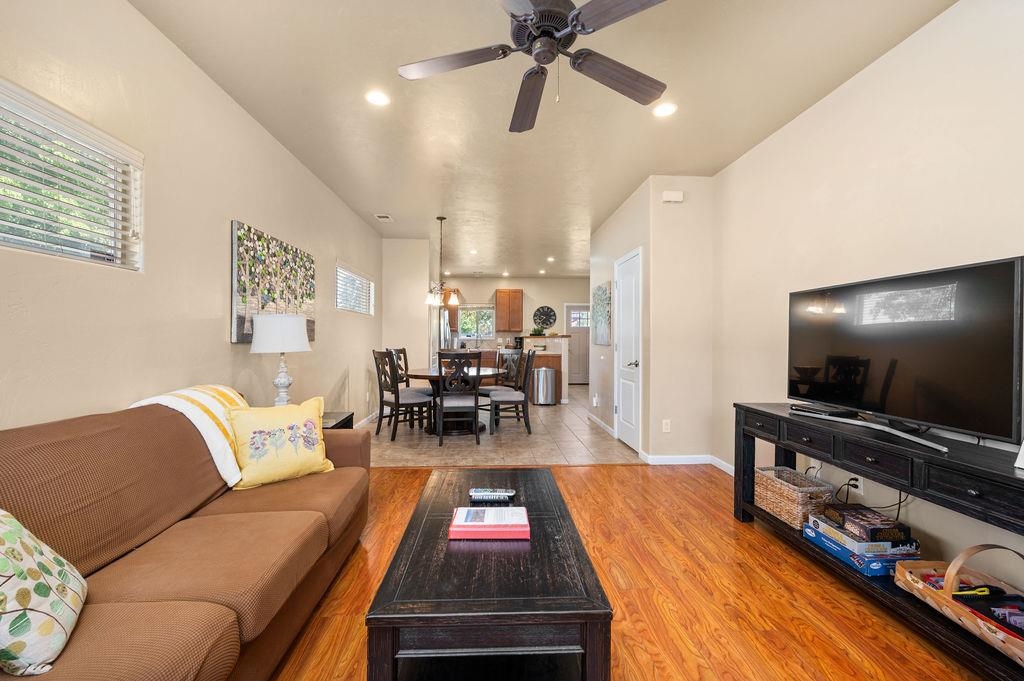 2436 1/2 Jack Creek Road Grand Junction, CO 81505 - Photo 6 of 36 a living room with furniture and a flat screen tv with wooden floor