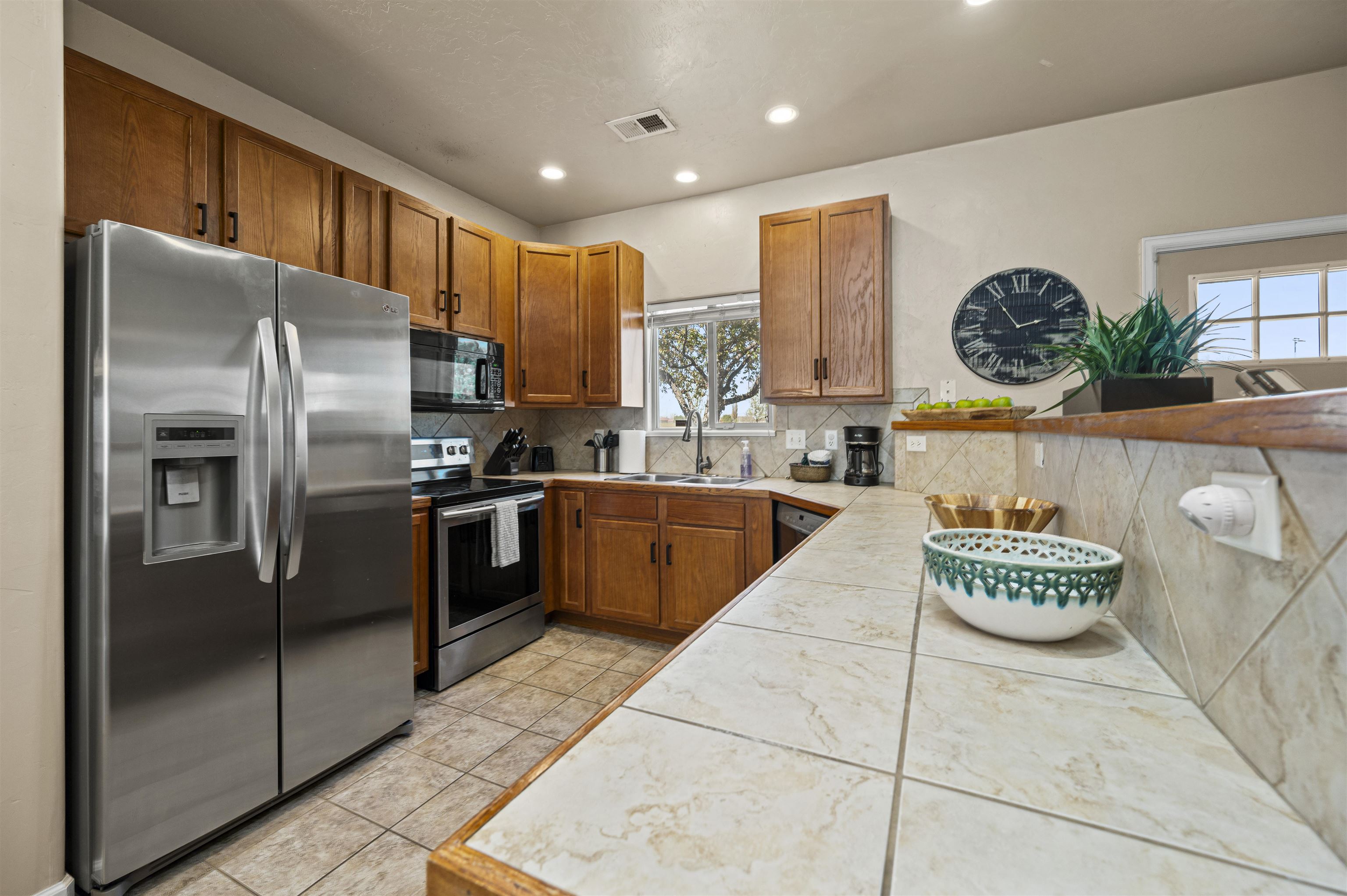 2436 1/2 Jack Creek Road Grand Junction, CO 81505 - Photo 8 of 36 a kitchen with stainless steel appliances granite countertop a refrigerator a sink a stove and a refrigerator