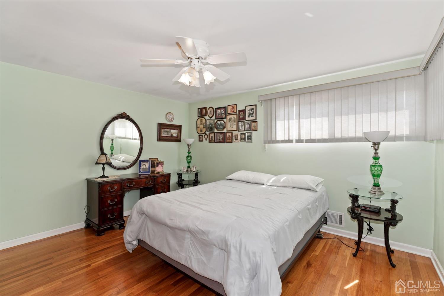 49 Albemarle Road Colonia, NJ 07067 - Photo 8 of 20 a bedroom with a bed and a chandelier