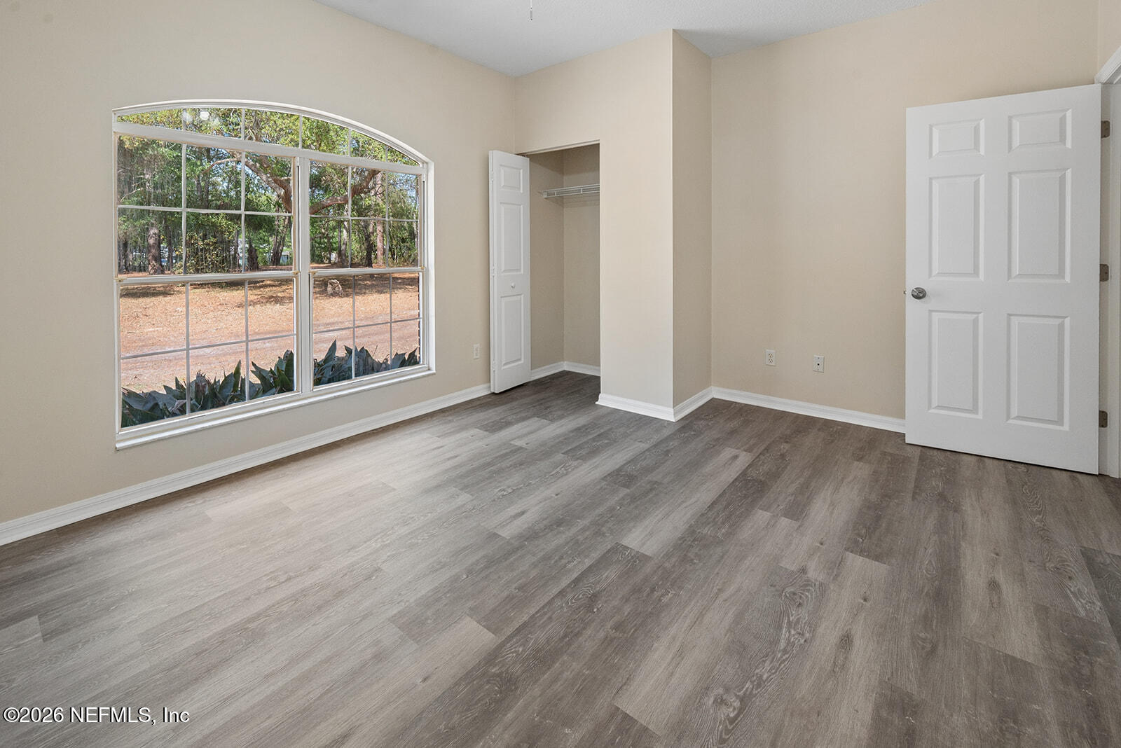 6240 Payne Road Keystone Heights, FL 32656 - Photo 14 of 43 an empty room with wooden floor and windows
