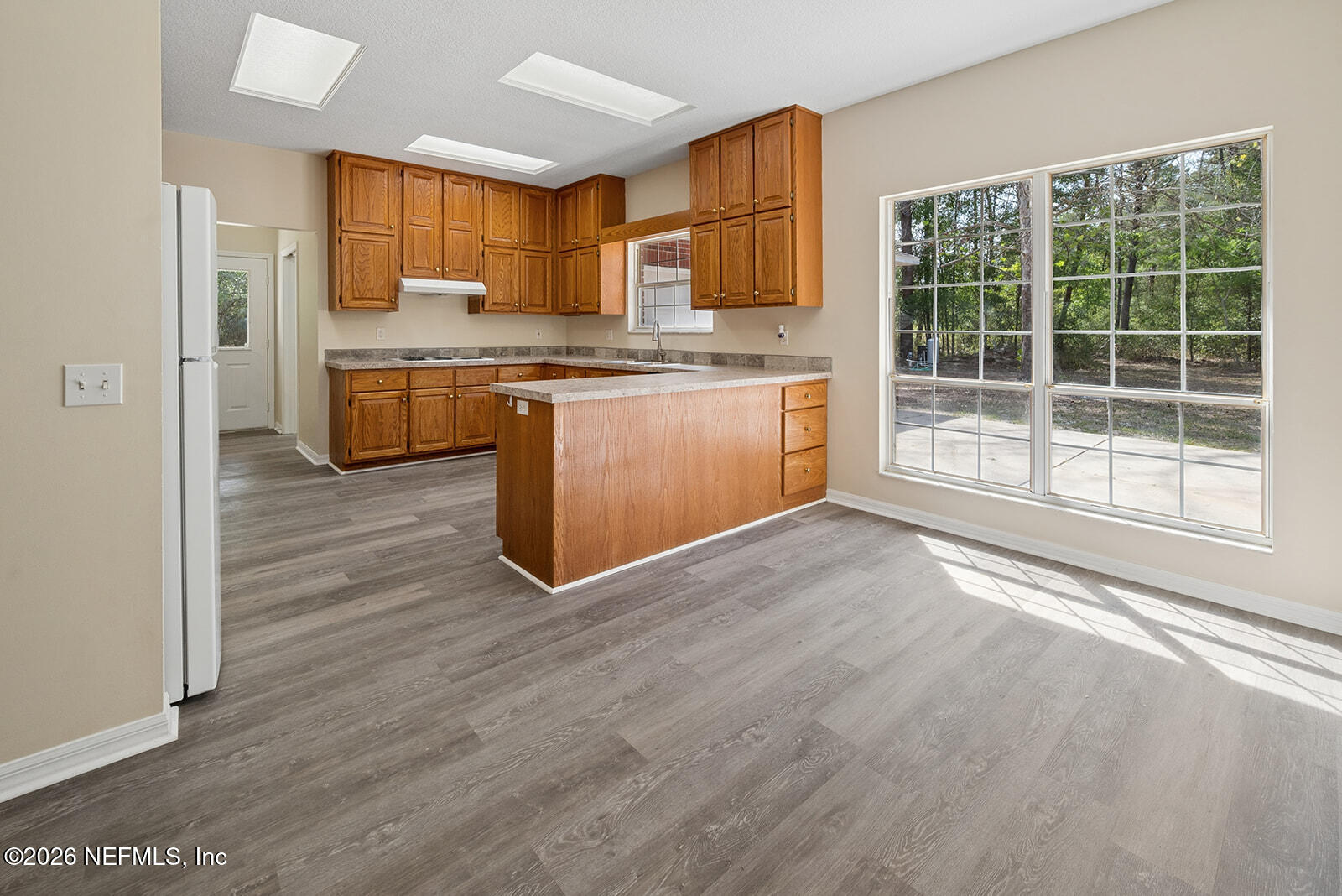6240 Payne Road Keystone Heights, FL 32656 - Photo 16 of 43 a view of kitchen with cabinets microwave and outdoor view