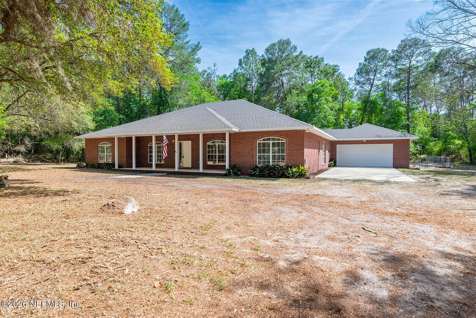 6240 Payne Road Keystone Heights, FL 32656 - Photo 2 of 43 a front view of a house with a garden