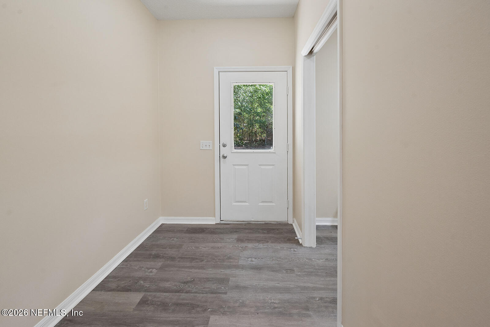 6240 Payne Road Keystone Heights, FL 32656 - Photo 21 of 43 a view of an empty room with wooden floor and a window