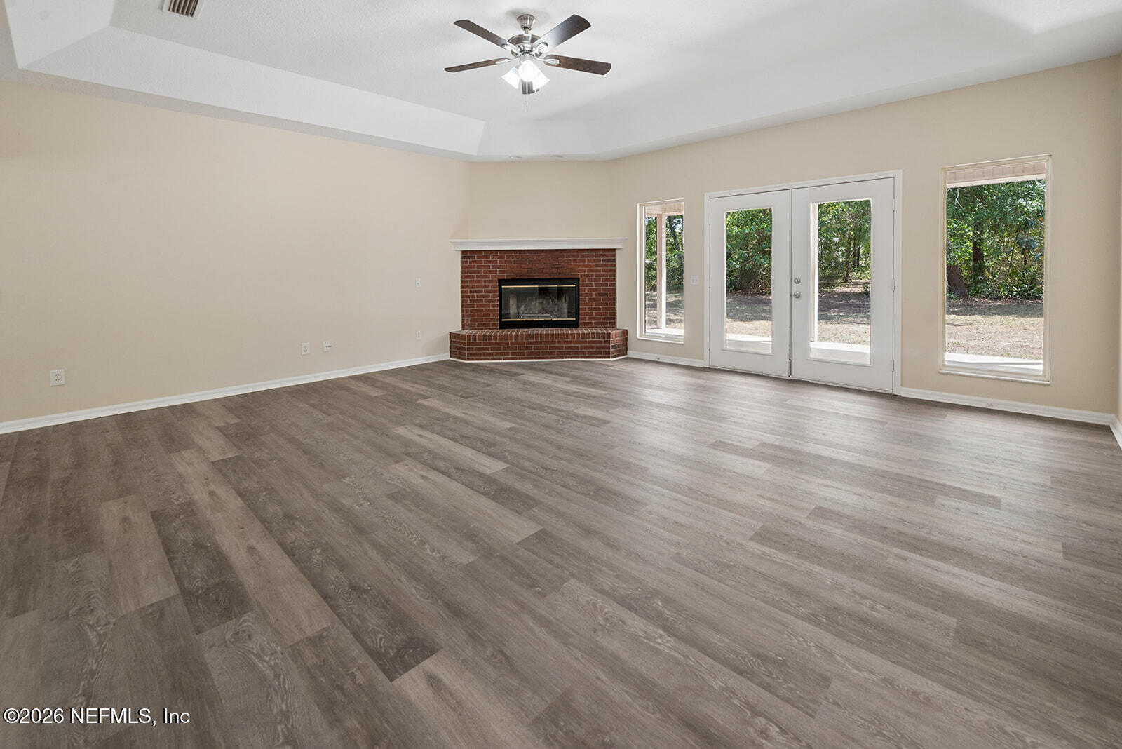 6240 Payne Road Keystone Heights, FL 32656 - Photo 24 of 43 a view of an empty room with wooden floor and a window