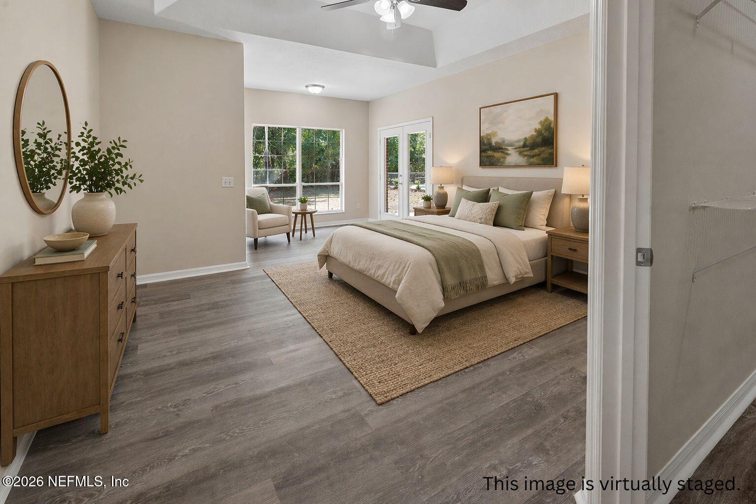 6240 Payne Road Keystone Heights, FL 32656 - Photo 32 of 43 a bedroom with a large bed and a chandelier
