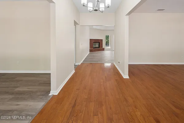 a view of a room with wooden floor