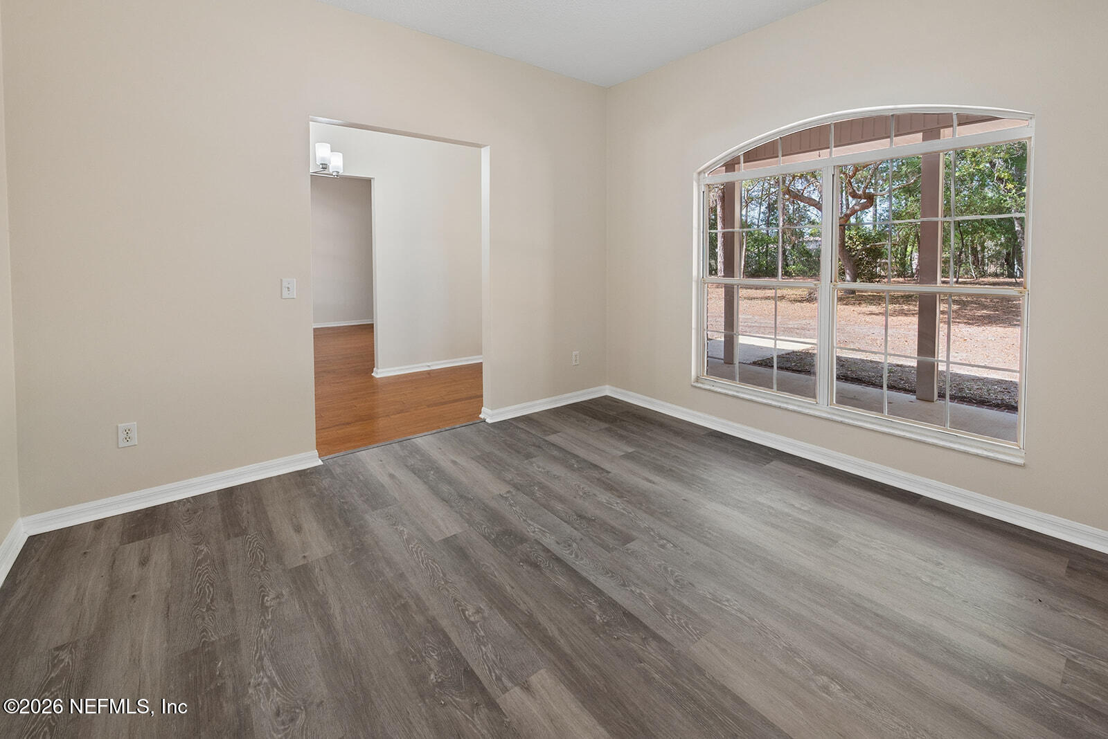 6240 Payne Road Keystone Heights, FL 32656 - Photo 6 of 43 an empty room with wooden floor and windows