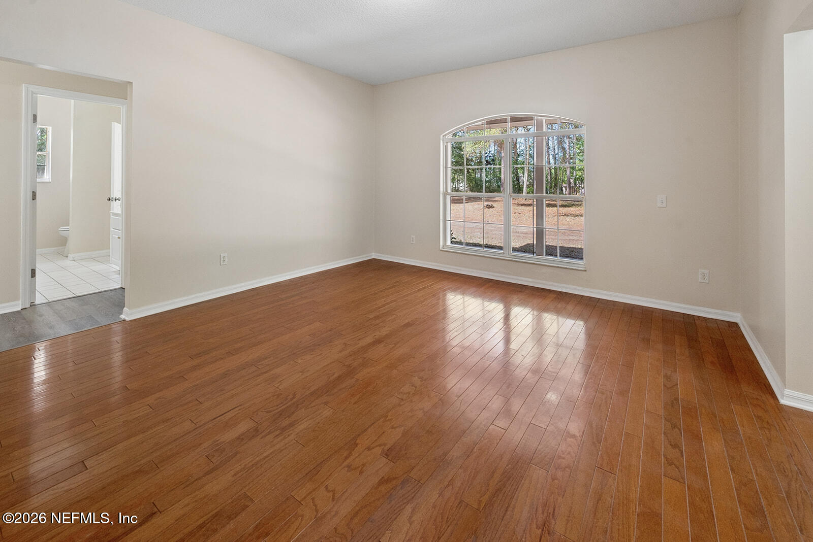 6240 Payne Road Keystone Heights, FL 32656 - Photo 9 of 43 an empty room with wooden floor and windows