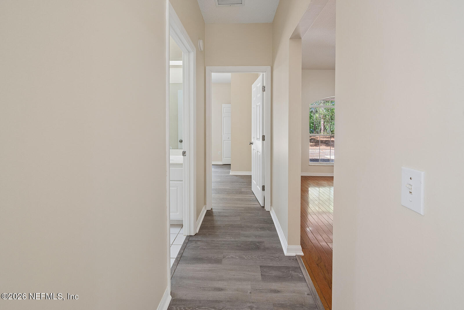 6240 Payne Road Keystone Heights, FL 32656 - Photo 10 of 43 a view of a hallway with wooden floor and a bathroom