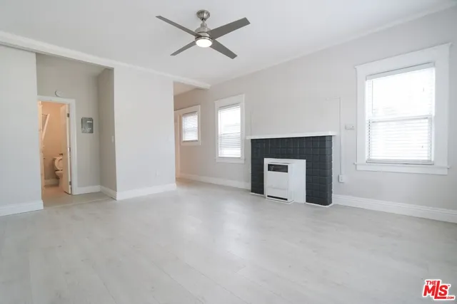 a big room with closet and a fireplace