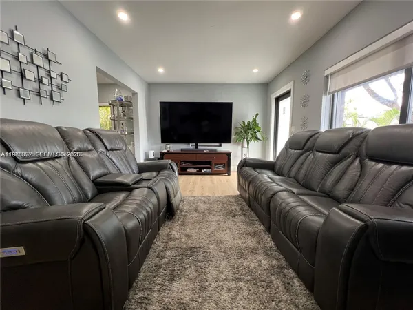 a living room with furniture and a flat screen tv