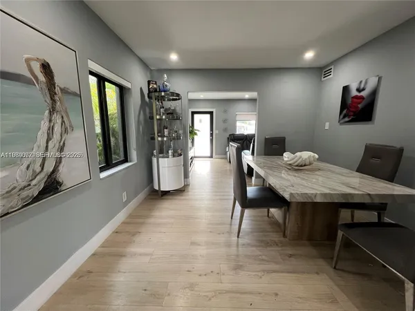 a dining room with furniture and window