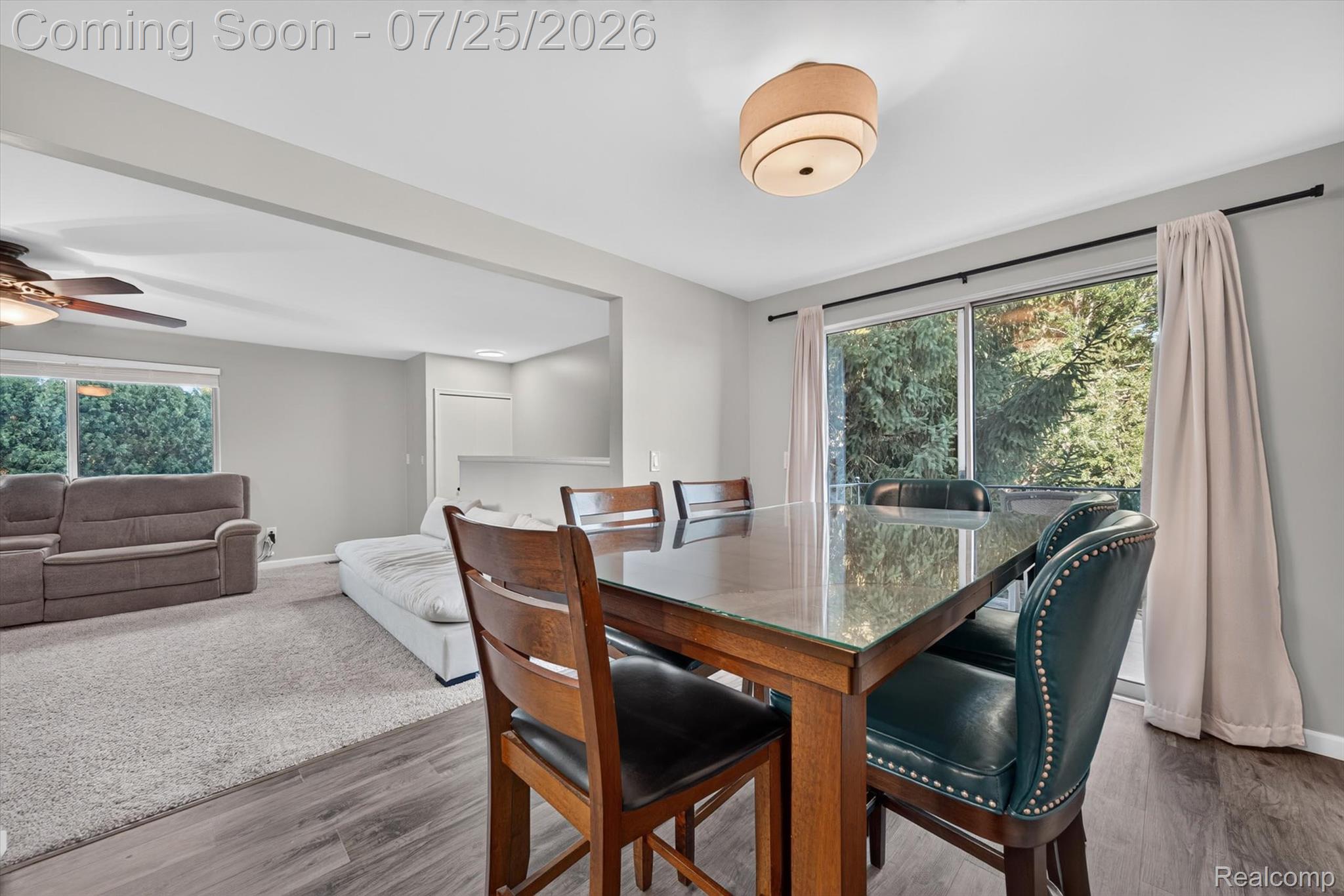 51116 South Foster Road New Baltimore, MI 48047 - Photo 10 of 31 Dining area featuring wood-finish flooring, a sliding glass door, and an overhead drum light fixture