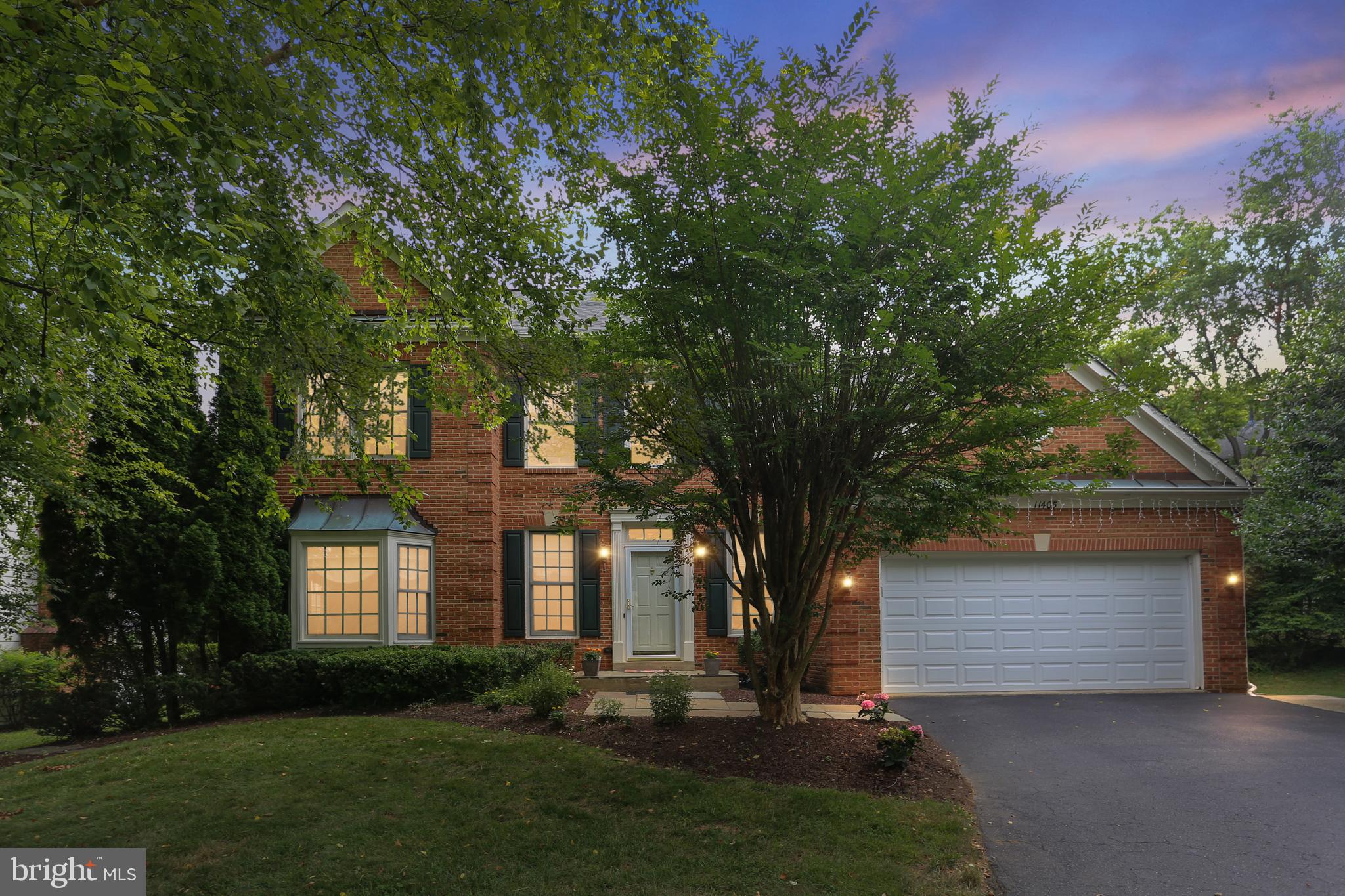 11405 Royal View Court Rockville, MD 20850 - Photo 1 of 75 a front view of a house with a garden and tree