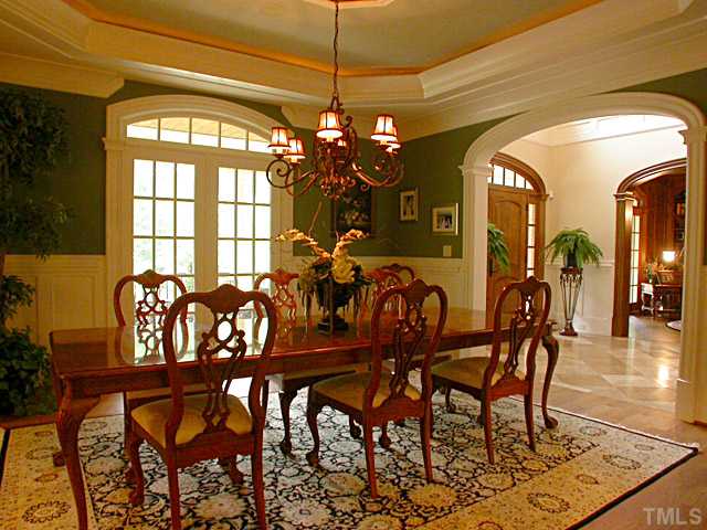 3032 Cone Manor Lane Raleigh, NC 27613 - Photo 3 of 12 a view of a dining room and chandelier fan and wooden floor