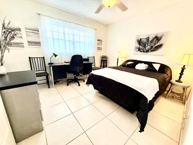 a bed room with a bed and a chair