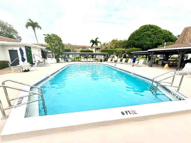 a view of swimming pool with outdoor seating and plants