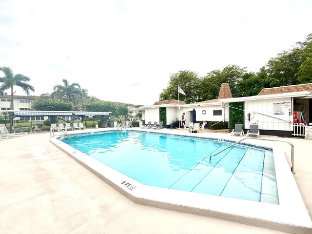 a view of a swimming pool with an outdoor seating