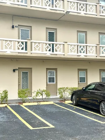 a view of a car parked in front of a building
