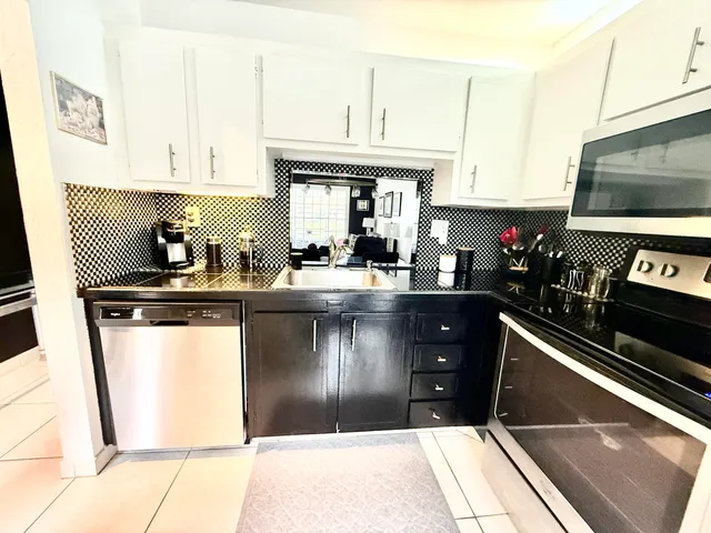a kitchen with a sink appliances and cabinets