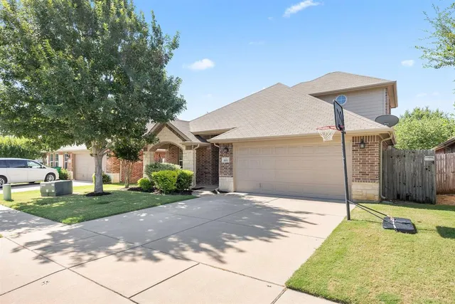 a backyard of a house with table and chairs