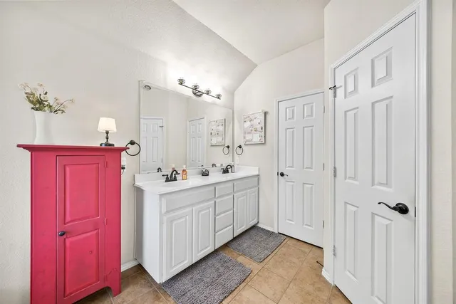 a bathroom with a sink vanity and a mirror