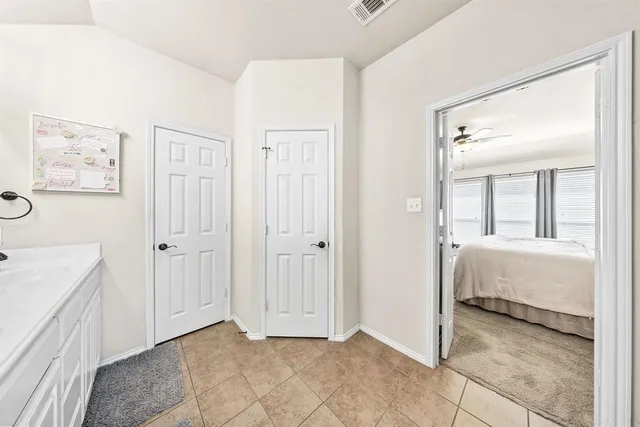 a room that has a bed and a mirror