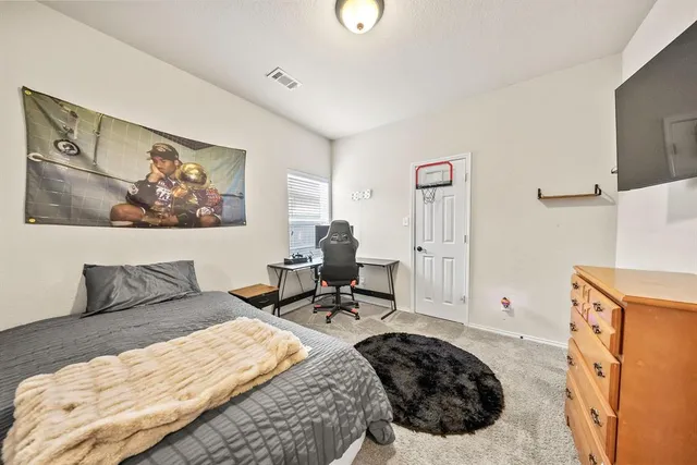 a bedroom with a bed and a couch