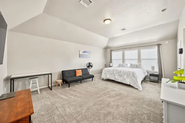 a bedroom with furniture and a bed