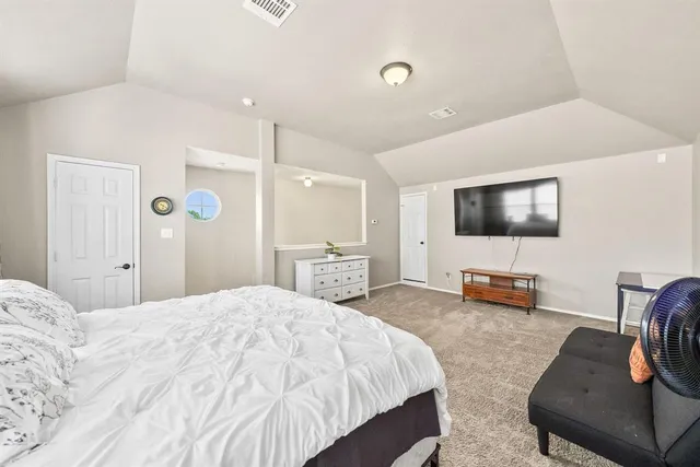 a bedroom with a bed and a flat screen tv