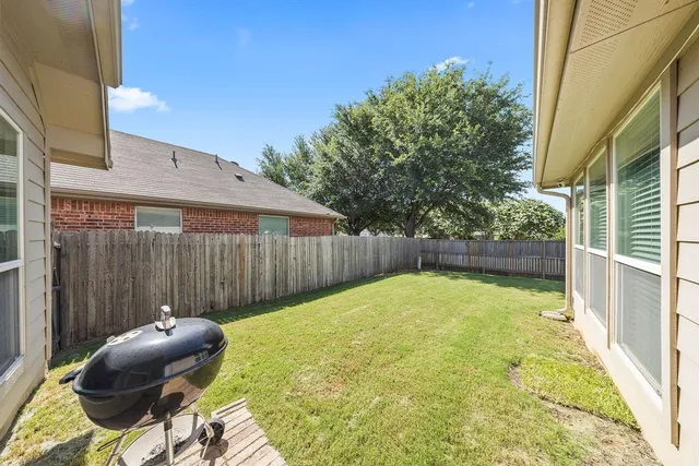 a backyard of a house with table and chairs