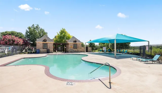 a swimming pool with outdoor seating and yard