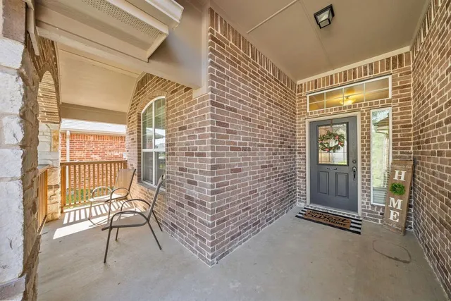 a view of front door of house with wooden floor