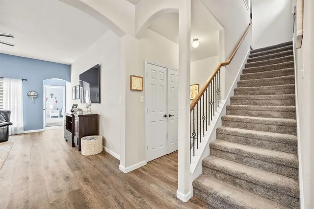 a view of entryway and hall with wooden floor