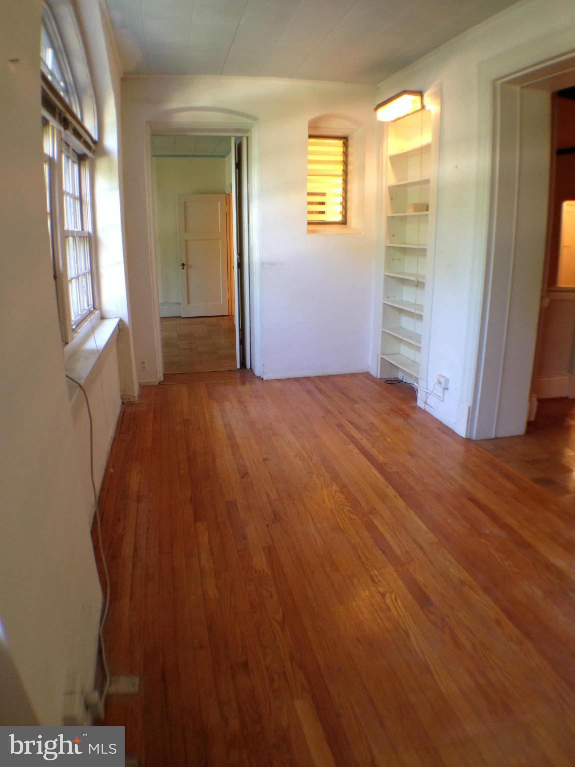 501 West University Parkway, Unit C1 Baltimore, MD 21210 - Photo 17 of 29 a view of an empty room with wooden floor and a window