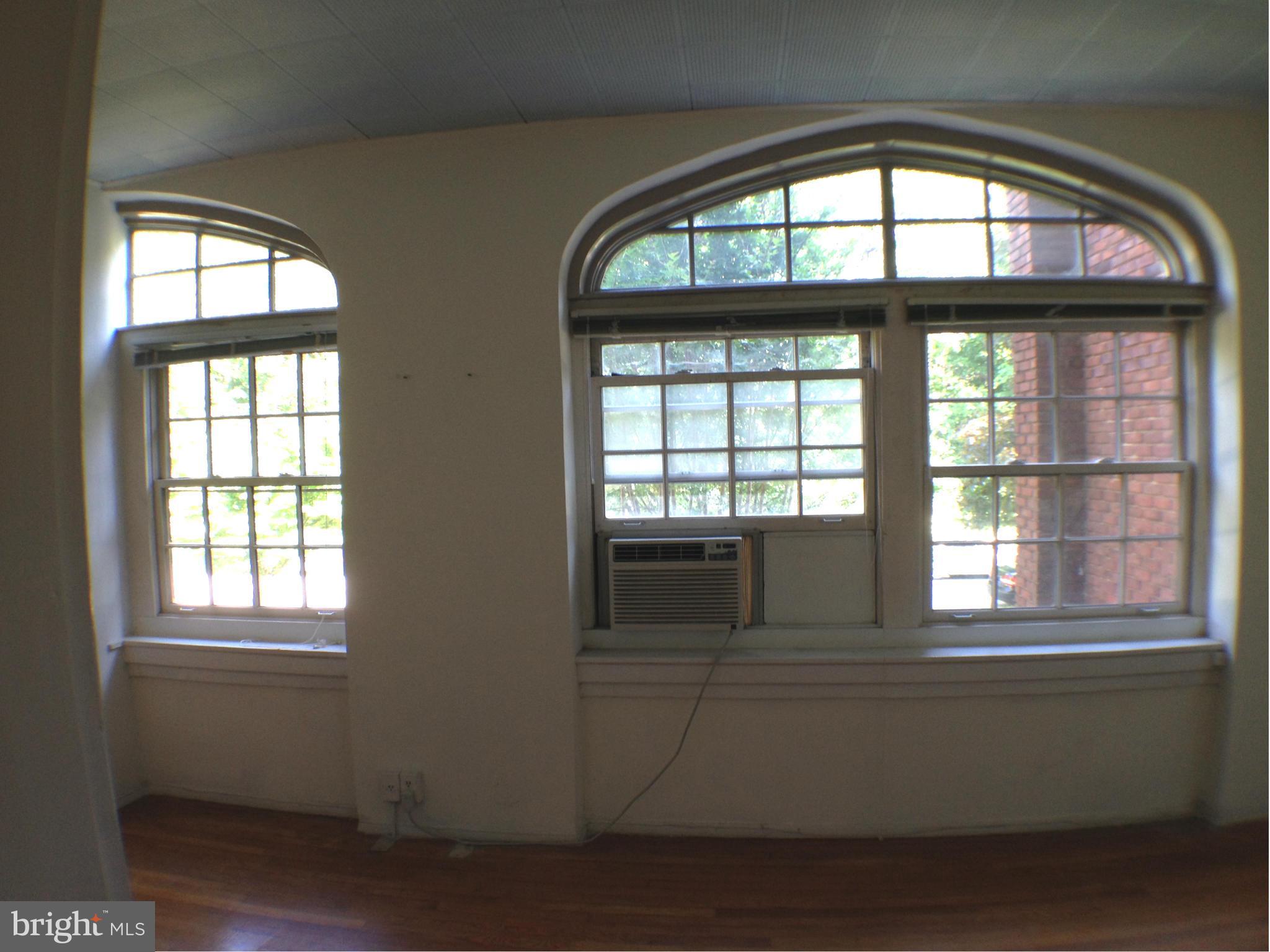 501 West University Parkway, Unit C1 Baltimore, MD 21210 - Photo 18 of 29 a living room with a large window