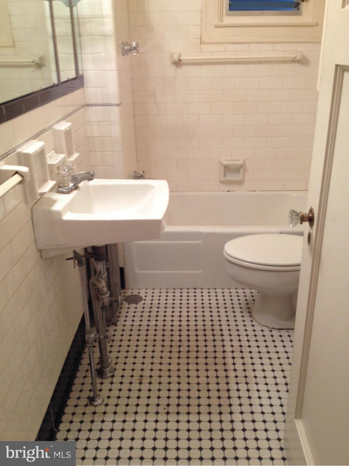 501 West University Parkway, Unit C1 Baltimore, MD 21210 - Photo 21 of 29 a bathroom with a sink a toilet and a mirror