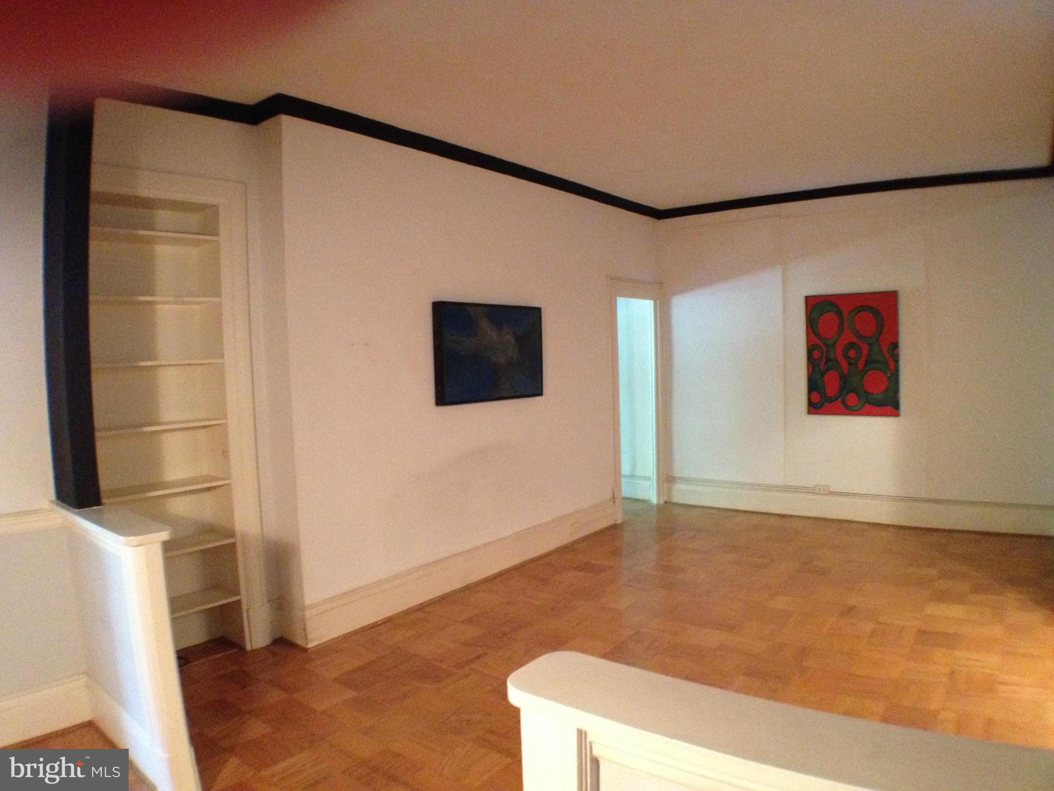 501 West University Parkway, Unit C1 Baltimore, MD 21210 - Photo 5 of 29 a living room with a flat screen tv