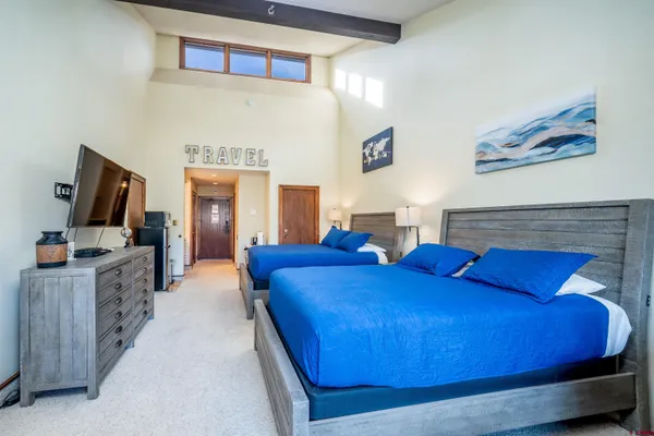 a bedroom with furniture and flat screen tv