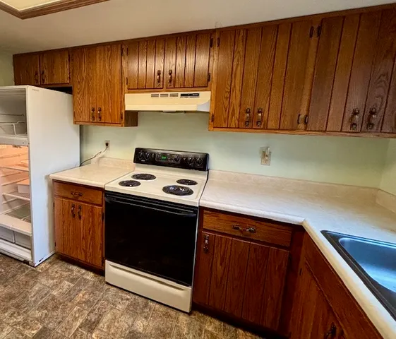 a kitchen with a stove and a cabinets