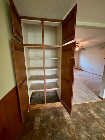 a view of walk in closet with empty racks