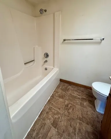 a bathroom with a sink mirror and toilet