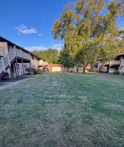 a view of a house with backyard and porch